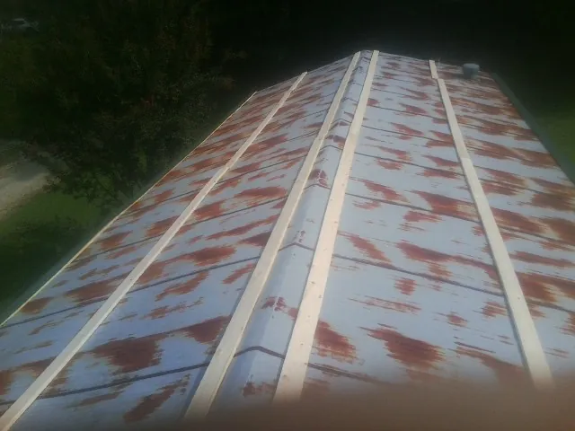 Rusted metal roof panels with new wood purlins before replacement — Storm Damage Roof Repair in South River by Roofing Brothers