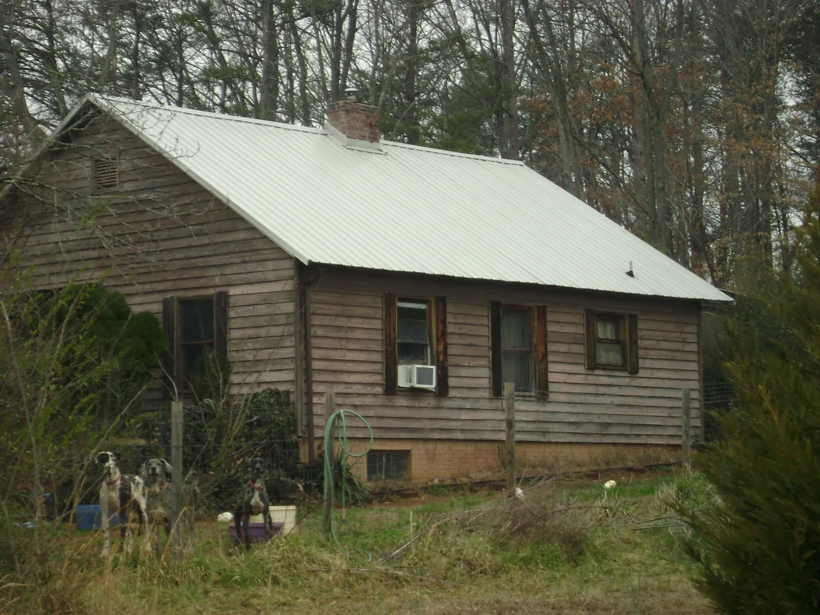 White metal roof on an old wood sided farmhouse, from a Metal Roof Installation job in South River